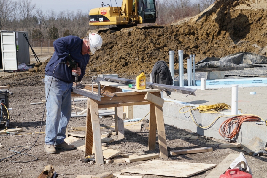 man cutting steel